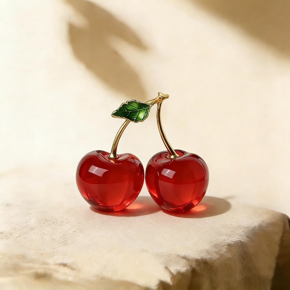Oversized hand-blown glass cherries as a home accent — bold, retro-glam, and genuinely sculptural in a way you won't find at any chain store.