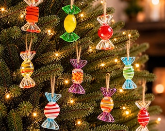 May include: A collection of ten glass candy-shaped ornaments hanging from a Christmas tree. Each ornament features distinct colors and patterns, including striped, solid, and speckled designs, all suspended by thin twine loops.
