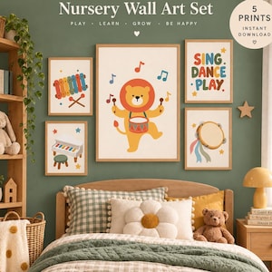 May include: A set of five nursery wall art prints featuring a lion playing a drum, a xylophone, a piano, a tambourine, and the text "SING DANCE PLAY". The prints are displayed on a green wall above a bed with a green checkered quilt and pillows.