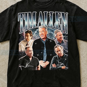 May include: Black t-shirt featuring a graphic of Tim Allen with the name "TIM ALLEN" in a retro font. The design includes multiple images of the actor. The shirt has a vintage, distressed look.