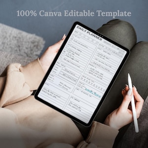 May include: A digital daily planner template on a tablet, held by a person. The planner features a clean, minimalist design with sections for to-do lists, goals, and notes. The text "100% Canva Editable Template" is at the top.
