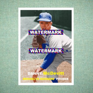 May include: A vintage baseball card featuring a pitcher in a grey and blue uniform with a blue cap. The text reads WATERMARK, DANNY MCDEVITT, BROOKLYN DODGERS PITCHER. The player wears a glove and stands on a dirt field with a white foul line visible.