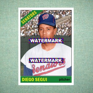 May include: A vintage baseball card featuring Diego Segui, a pitcher for the Senators. The card displays the player wearing a blue cap with a red W logo and a white jersey with blue sleeves. The text SENATORS, WATERMARK, and DIEGO SEGUI are visible.