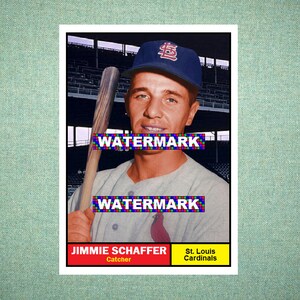 May include: A vintage baseball card featuring Jimmie Schaffer, a St. Louis Cardinals catcher. The player wears a blue cap with a red logo and a grey jersey with a red cardinal emblem. A wooden bat is held upright. The text reads WATERMARK twice.