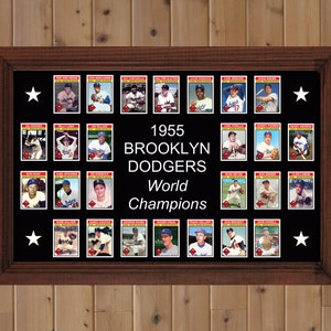 May include: A framed black and white photo of the 1955 Brooklyn Dodgers World Champions. The photo features a collage of baseball cards of each player on the team. The text "1955 Brooklyn Dodgers World Champions" is printed in white on a black background.