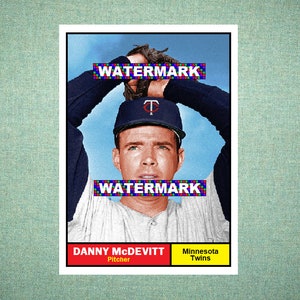 May include: A vintage baseball card featuring Danny McDevitt, a pitcher for the Minnesota Twins. The player wears a dark blue cap with a red TC logo and a light grey jersey with dark sleeves. The card includes the text WATERMARK twice.
