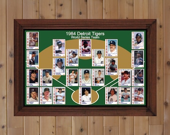 May include: A framed collage of baseball cards featuring the 1984 Detroit Tigers World Series team. The cards are arranged in a diamond shape on a green background with gold accents. The text "1984 Detroit Tigers World Series Team" is at the top of the collage.