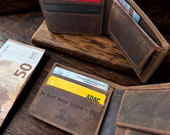 May include: A brown leather wallet with multiple card slots and a bill compartment. The wallet is open, revealing cards and a 50 Euro bill. Text on the wallet reads "Du bist mein Glück - 2022".