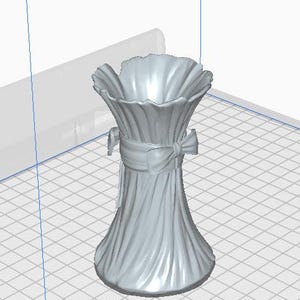 May include: A light gray vase with a ruffled top and a ribbon tied around the middle. The vase has a textured, vertical pattern and a flared base. The overall design is elegant and decorative.