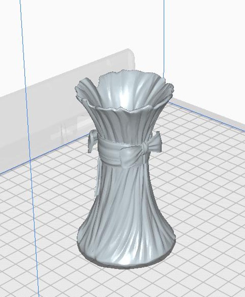 May include: A light gray vase with a ruffled top and a ribbon tied around the middle. The vase has a textured, vertical pattern and a flared base. The overall design is elegant and decorative.