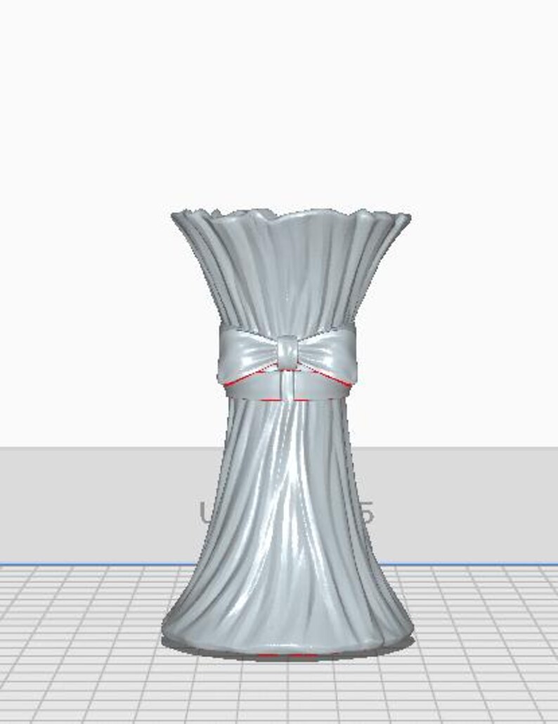 May include: A light gray vase with a ruffled top and a bow tied around the middle. The bow has red trim. The vase has a textured, pleated design. The base of the vase is a darker gray.