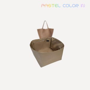 May include: A beige tote bag with an open interior, showcasing a zippered pocket. A second, similar tote bag is visible in the background. The text "PASTEL COLOR IN" is displayed in pastel colors at the top of the image.