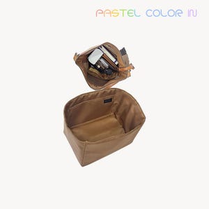 May include: Two brown tote bags, one open and filled with items, the other empty. The top bag has a leather strap and contains various objects. The bottom bag is open, showing its interior. The text "PASTEL COLOR IN" is at the top.