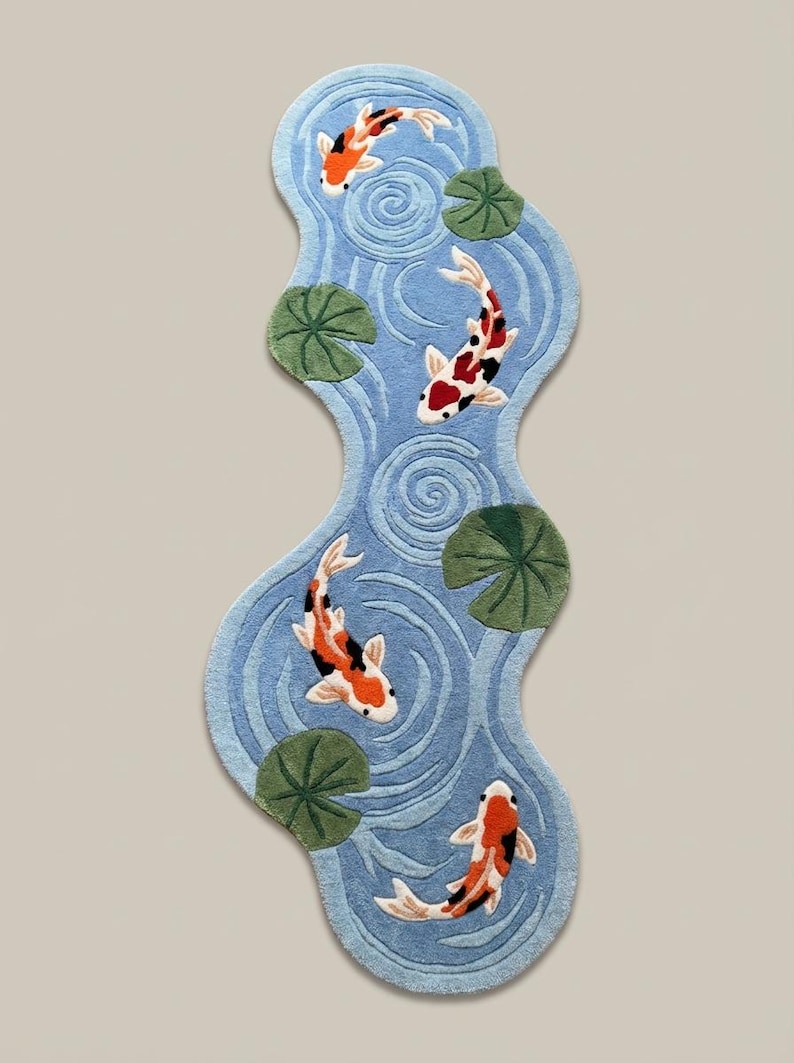 Irregular shaped koi pond runner rug with orange koi fish and green lily pads on light blue background