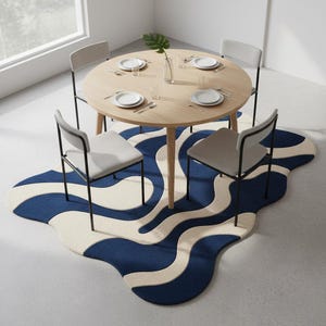 Soft plush abstract rug with flowing blue and cream waves, perfect for modern living rooms and home décor setups.