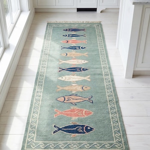 Hand knotted fish runner rug in sea green wool with colorful fish motifs for coastal kitchen and hallway décor