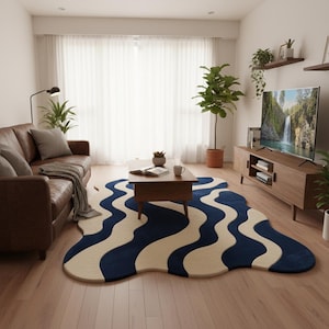 Artistic modern area rug featuring sculpted wave patterns in blue and cream, complementing minimalist home décor.
