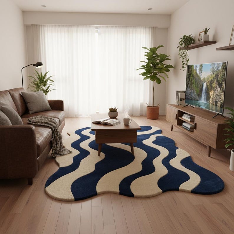 Artistic modern area rug featuring sculpted wave patterns in blue and cream, complementing minimalist home décor.