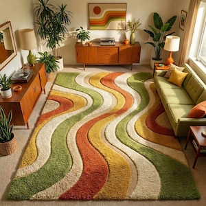 May include: A retro-style shag rug with a wavy pattern in a living room. The rug's design incorporates green, yellow, orange, and cream stripes. The room also features a green sofa, wooden furniture, and plants, creating a vintage aesthetic.