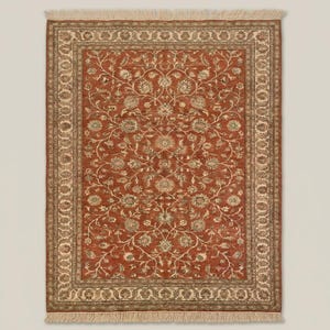 Vintage Oushak style rug with rust and ivory tones placed under armchair highlighting classic decor styling
