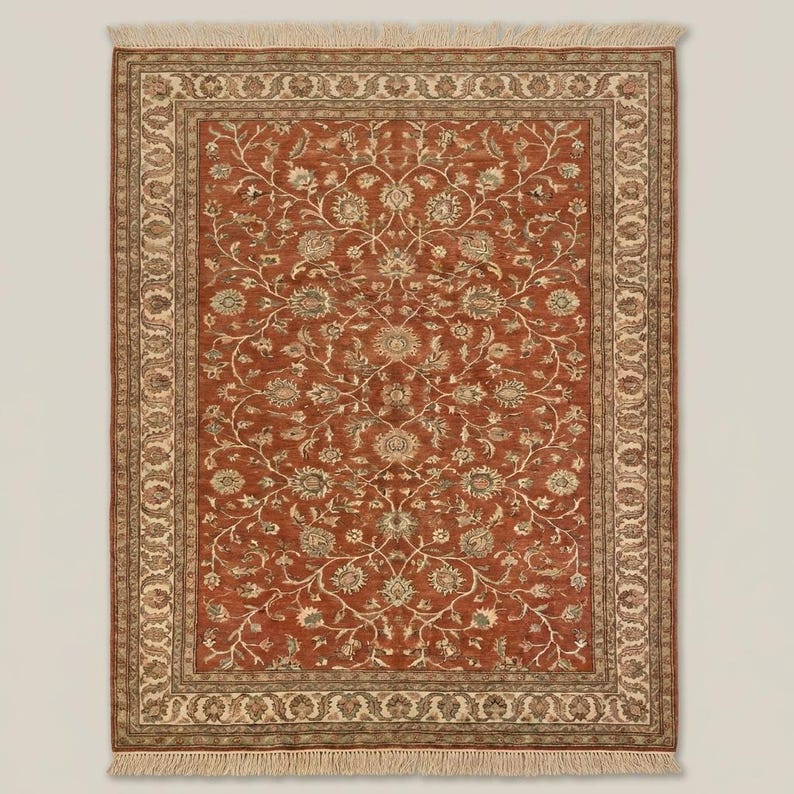 Vintage Oushak style rug with rust and ivory tones placed under armchair highlighting classic decor styling