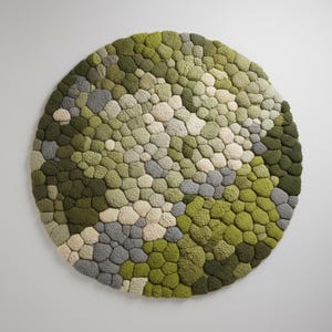 Textured green and grey round rug for biophilic living room decor.