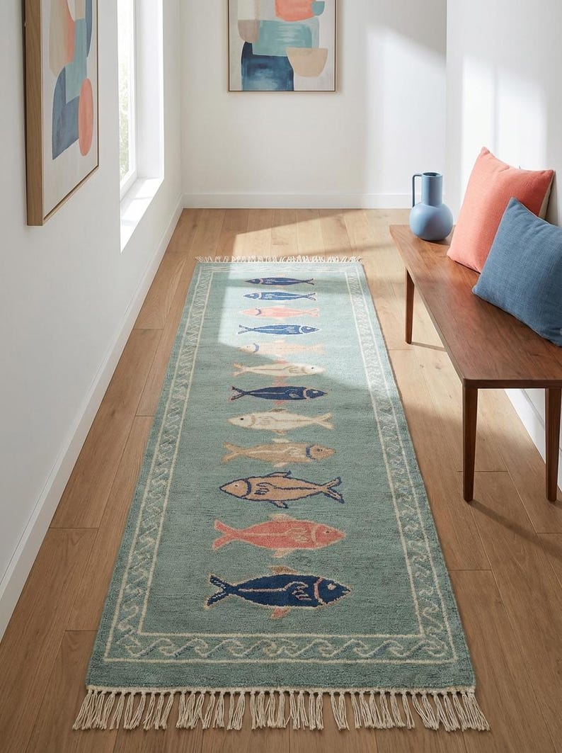 Handmade nautical runner rug with multicolor fish pattern on green background for beach house interiors