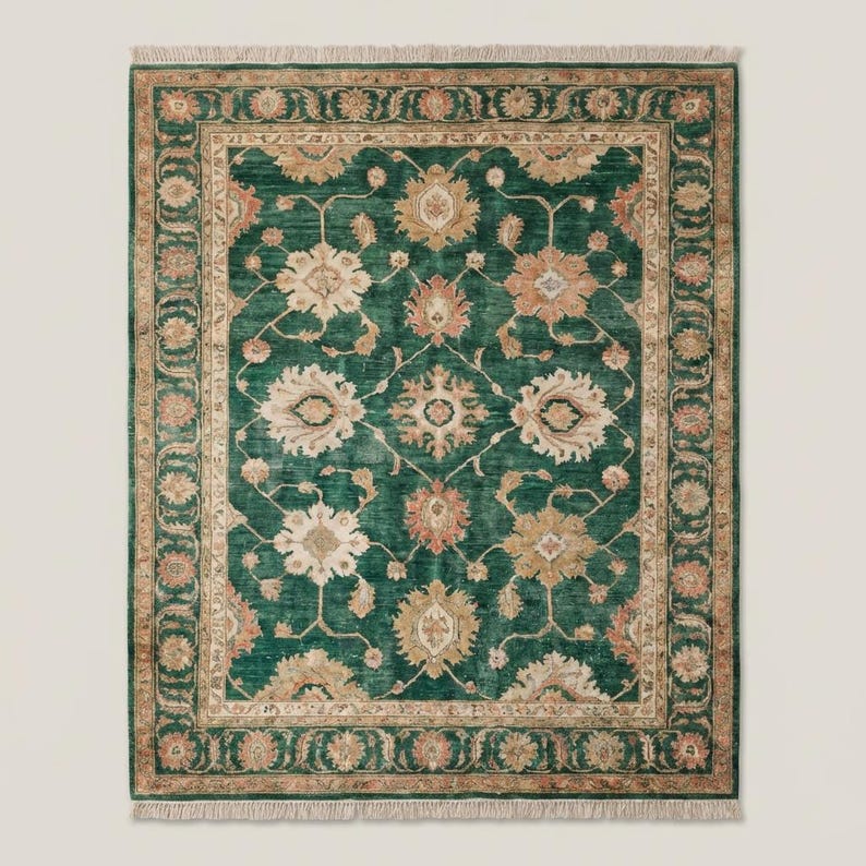 Green floral Oushak rug carpet with traditional Persian motifs styled under armchair in contemporary interior setting