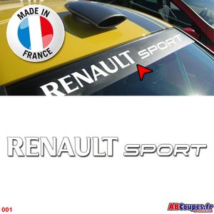 Puede incluir: Un coche amarillo con una franja negra en el parabrisas, con el texto blanco "RENAULT SPORT". Una pegatina "Made in France" con la bandera francesa es visible. Una toma de aire negra está montada en el capó.