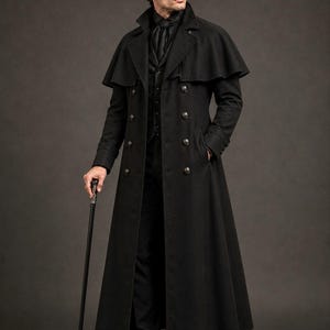 May include: A long black wool-blend overcoat featuring a shoulder cape, double-breasted button closure, and a high collar. The coat is worn over a matching black vest and trousers, paired with black dress shoes and a black walking cane.