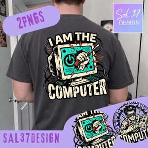 May include: A charcoal gray t-shirt featuring a graphic print of a computer monitor with a hand holding a screwdriver breaking through the screen. The text reads I AM THE COMPUTER, with binary code and red lightning bolts surrounding the monitor.