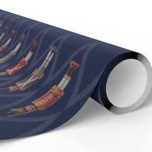 May include: A roll of wrapping paper featuring a repeating pattern of nutcracker figures in red, white, and brown uniforms. The nutcrackers are arranged in a curved, rhythmic sequence against a solid dark navy blue background with light blue lines.