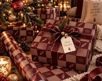 May include: A square gift box wrapped in brown and burgundy checkered paper featuring nutcracker and snowflake patterns. The box is tied with a burgundy ribbon, topped with a sprig of holly, and includes a tag that reads Merry Christmas.