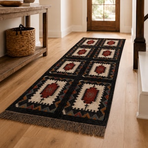Bohemian black geometric rug with aztec tribal medallion pattern, handwoven wool and jute flatweave, rustic boho living room decor
