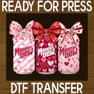 May include: Three Mountain Dew cans with Valentine's Day designs. Each can has a different pattern of hearts, lips, and keys, and is topped with a decorative bow. The words "READY FOR PRESS" and "DTF TRANSFER" are at the top and bottom.