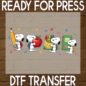 May include: A DTF transfer sheet featuring four Snoopy characters with school supplies. One holds a large yellow pencil, another a red apple, one a box of colorful crayons, and the last a green notebook labeled NOTE BOOK with a heart icon.