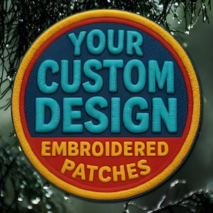 May include: Circular embroidered patch with the text "YOUR CUSTOM DESIGN EMBROIDERED PATCHES". The patch has a blue center, a red border, and a yellow outer edge. The text is in a teal color.