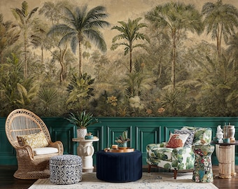 May include: A room featuring a tropical forest mural, a wicker chair with a patterned cushion, a floral armchair, and a navy blue ottoman. The room has a dark green wainscoting and a patterned rug.