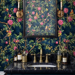 Luxurious bathroom featuring a navy chinoiserie floral wallpaper with detailed birds and blossoms. The mural is paired with a black marble vanity, gold faucets, and wall sconces, creating a dramatic statement wall with timeless botanical elegance.