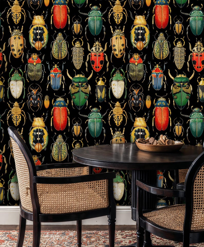 Colorful beetle wallpaper behind a small dining table with rattan chairs and wooden accents. The insect illustration mural adds personality and museum-style charm to the cozy dining space.