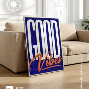 May include: A rectangular framed poster featuring a deep blue background with the large white text GOOD and the orange script text Vibes layered over it. The artwork is displayed in a thin silver frame, showcasing a bold graphic design.