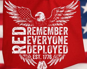 May include: Red tote bag featuring a white eagle graphic with outstretched wings and the American flag incorporated. The text reads "REMEMBER EVERYONE DEPLOYED EST. 1776" in white. Includes two dog tags.