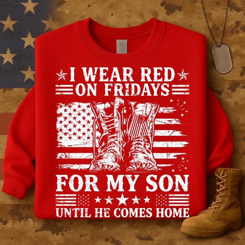 May include: Red sweatshirt with the text "I WEAR RED ON FRIDAYS FOR MY SON UNTIL HE COMES HOME." The design includes an American flag and combat boots. A tan boot is visible in the lower right corner.