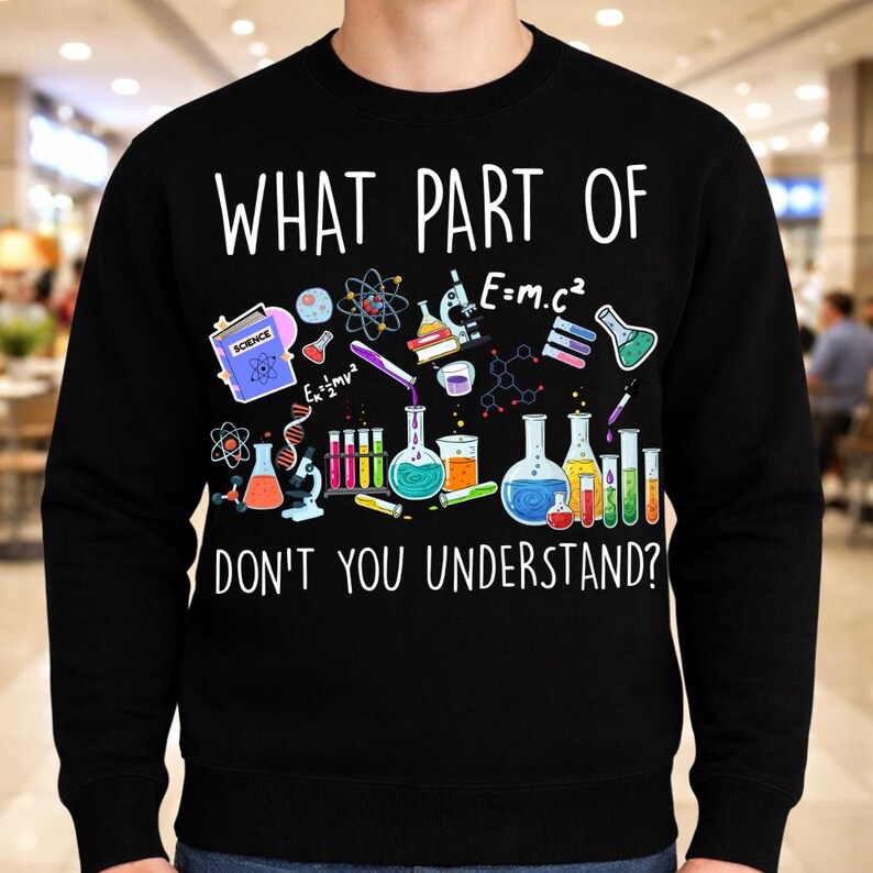 Może przedstawiać: Czarna bluza z napisem "WHAT PART OF DON'T YOU UNDERSTAND?" i grafiką o tematyce naukowej. Grafika zawiera zlewki, prob&oacute;wki, mikroskop i struktury molekularne w r&oacute;żnych kolorach.