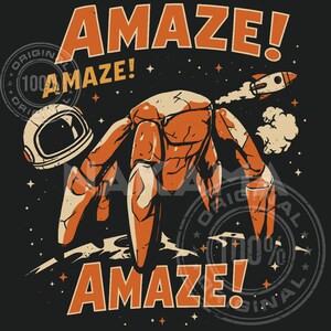 May include: A graphic illustration on a dark background featuring a multi-legged orange robot standing on a cratered surface. An astronaut helmet sits to the left, a small rocket flies above, and the text AMAZE! is printed in large orange letters.