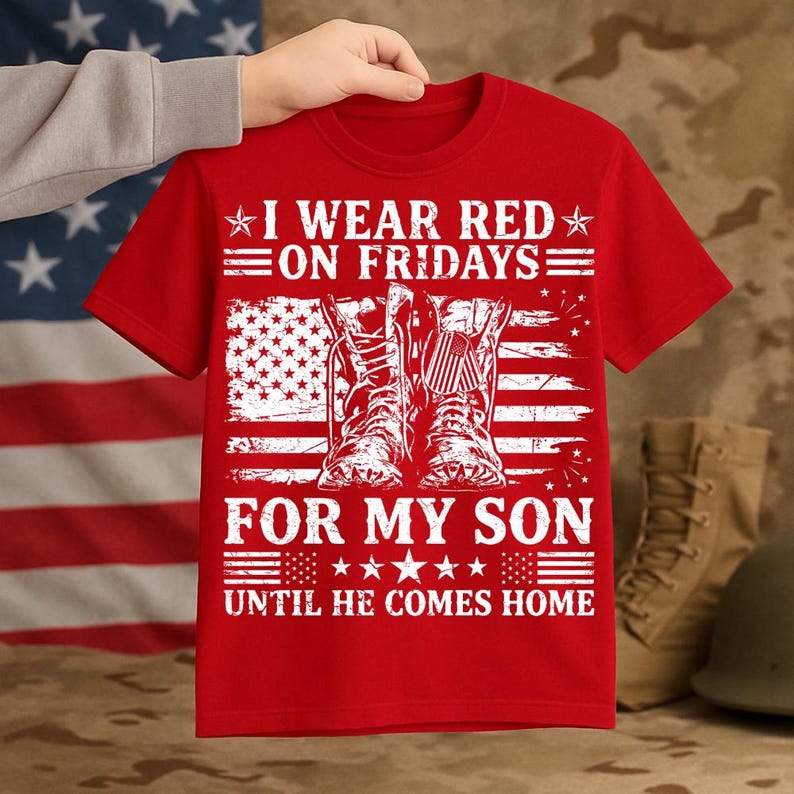 May include: Red t-shirt with the text "I WEAR RED ON FRIDAYS FOR MY SON UNTIL HE COMES HOME." The design includes an American flag and a pair of boots.