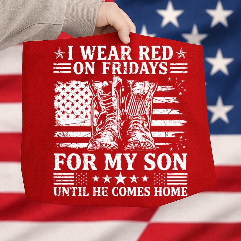 May include: Red tote bag with white text: "I WEAR RED ON FRIDAYS FOR MY SON UNTIL HE COMES HOME." The design includes an American flag and a pair of boots. The bag is held up by a person.