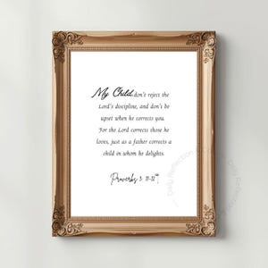 May include: A framed print with a gold-colored ornate frame. The print features elegant script text that reads "My Child... Proverbs 3: 11-12". The background is white, and the overall aesthetic is classic and inspirational.