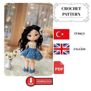 Puede incluir: Una muñeca de ganchillo hecha a mano con cabello negro, que lleva una falda azul de lunares y zapatos a juego. La muñeca tiene una parte superior color crema y una flor en el pelo. La imagen incluye el texto "CROCHET PATTERN" y "DOWNLOAD".