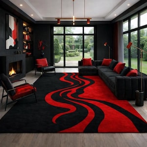 May include: A large rectangular area rug featuring a bold, flowing wave pattern in vibrant red and deep black. The rug covers a significant portion of the floor, contrasting with the dark interior decor and providing a central focal point.